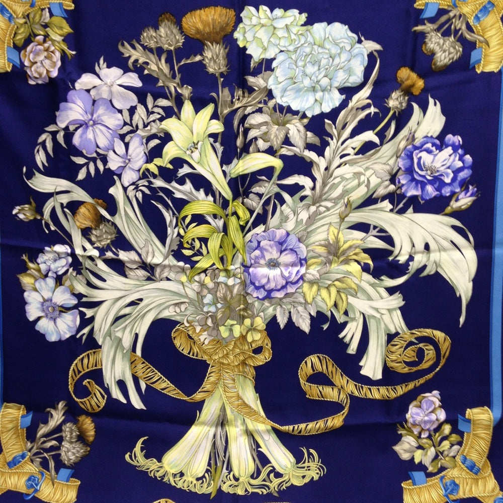 Hermes Regina Floral Scarf over a Blue Backgound
