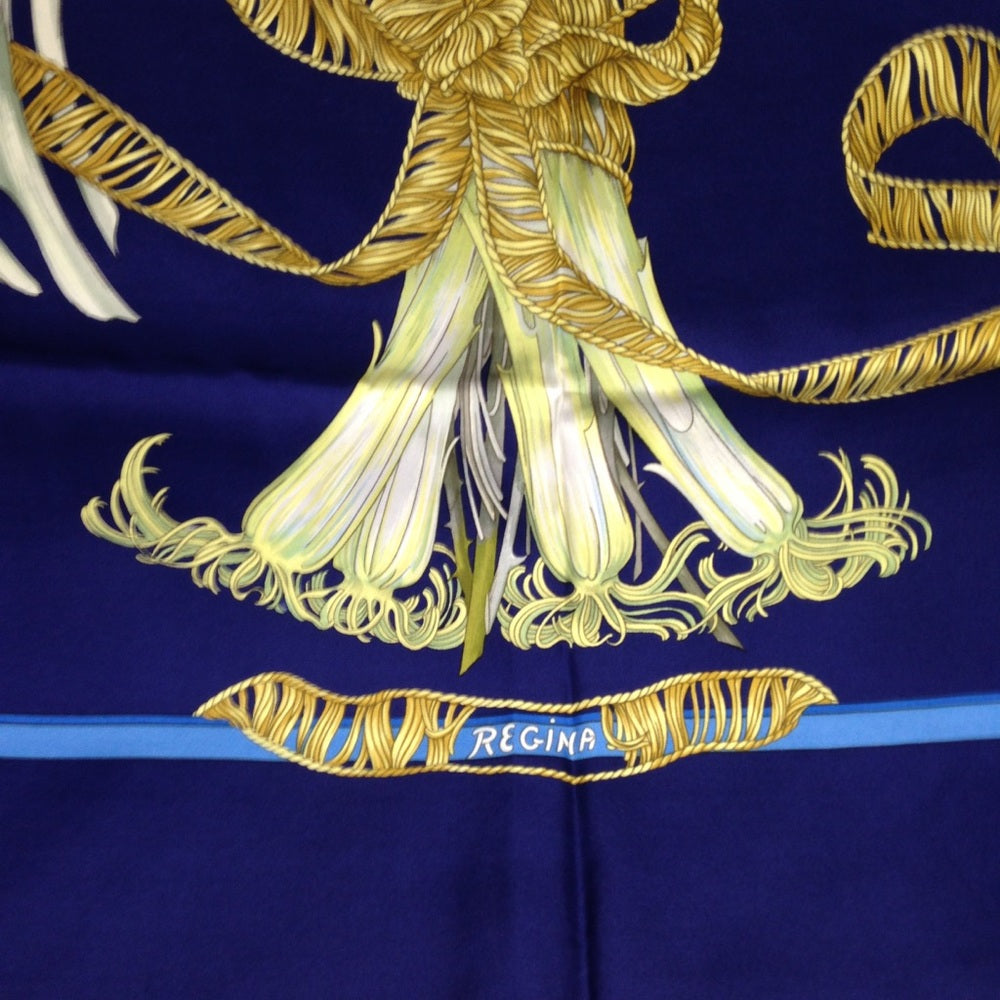 Hermes Regina Floral Scarf over a Blue Backgound
