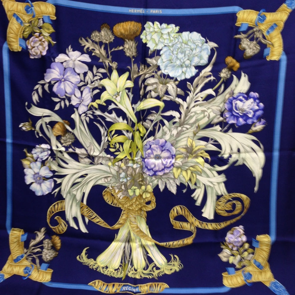 Hermes Regina Floral Scarf over a Blue Backgound