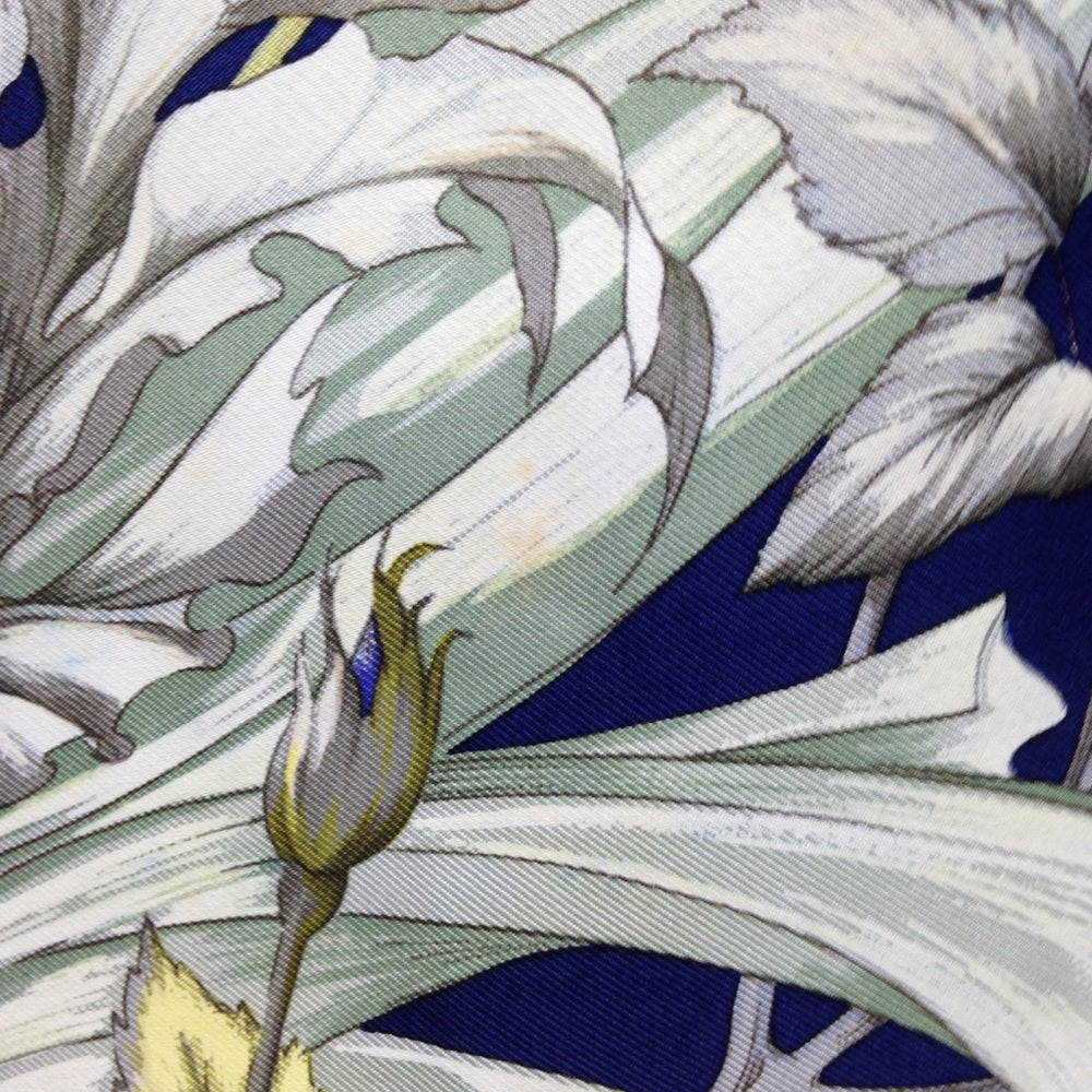Hermes Regina Floral Scarf over a Blue Backgound