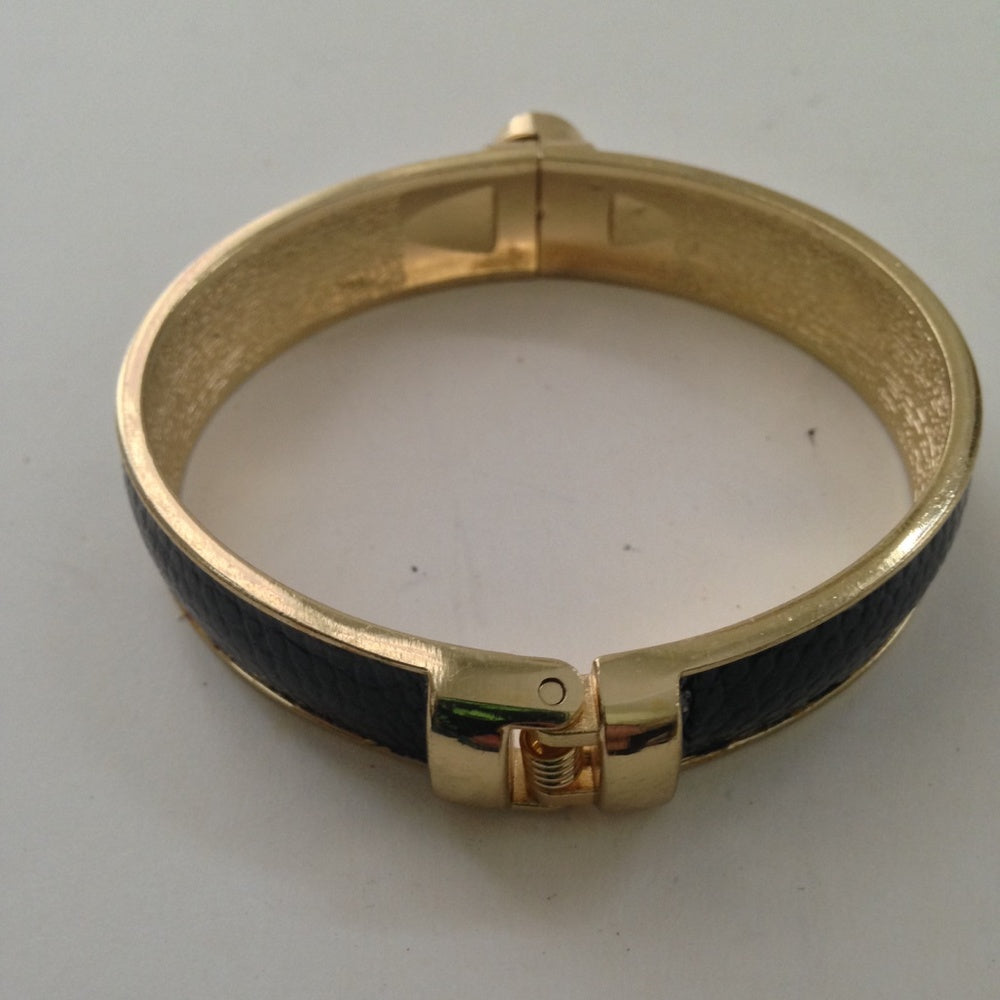Vintage Gold Tone, Black Hinged Bangle Bracelet with Blue Faux Sapphire