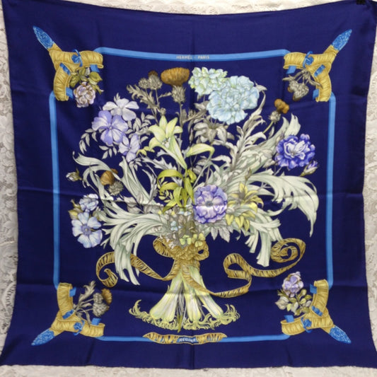 Hermes Regina Floral Scarf over a Blue Backgound